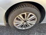 a close up of a tire on a white car