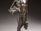 an image of a bronze statue of a man holding a basket
