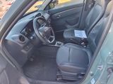 the interior of a small car with a steering wheel and a dashboard