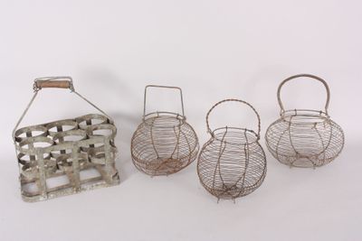four small metal baskets with handles and handles on a white surface