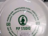 a white frisbee with a green logo on it