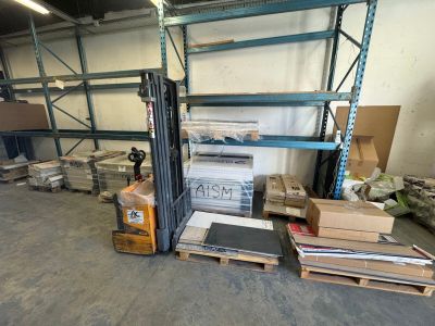 a fork lift in a warehouse filled with boxes and pallets
