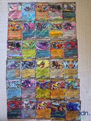 a pile of pokemon cards sitting on top of a table
