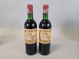 two bottles of wine sitting on top of a table next to each other