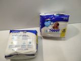 two bags of diapers on the counter next to each other