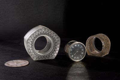 three different types of clocks sitting on a table