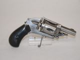 an old revolver with a black handle on a white surface