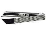 a close up of a black and white tie with a name on it