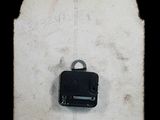 a small piece of luggage sitting on top of a piece of paper