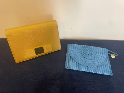 yellow and blue purses are sitting on a black surface