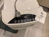 a white toilet with a black and white button on it