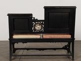 a black bench with a clock on top of it