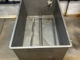 an image of a stainless steel sink in a garage