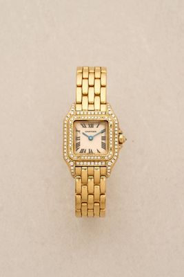 a close up of a gold watch with diamonds on it