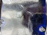 a close up of a glass plate with a knife and fork in it