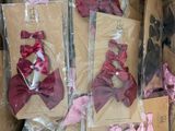 a cardboard box filled with lots of pink and purple bows