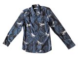 the shirt is long sleeved and has a pattern of horses on it
