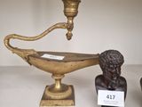 a statue of a man and a lamp on a table