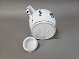 a white cup with blue stars on it next to a white cup