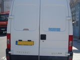 a white van that is parked on the side of the street
