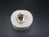 a close up of a ring with a purple stone inside of it