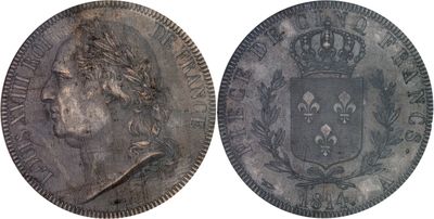 a close up of two silver coins with a crown on them