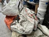 a pile of garbage sitting on the floor in a garage