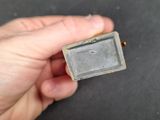 someone is holding a small piece of metal in their hand