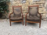 pair of vintage upholstered armchairs with upholstered cushions