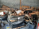 a large pile of wood in a warehouse with a lot of other items