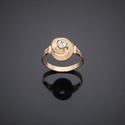 a gold ring with a diamond set in the center