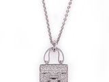 a white gold necklace with a lock and chain on a white background