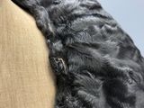 a black dog that is laying down on a couch