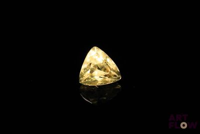 a yellow diamond on a black background