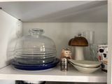 a white shelf with a glass bowl and a bowl on it