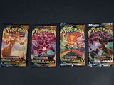 trois paquets de cartes à collectionner Pokémon posés sur une surface noire