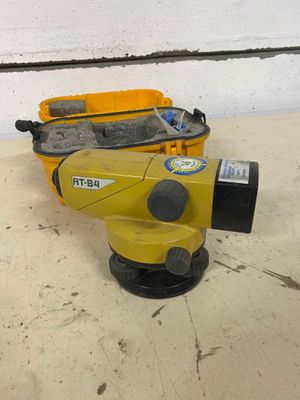 a close up of a yellow and black surveying device on a table