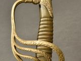 an old gold sword with a snake on the handle and a snake on the blade