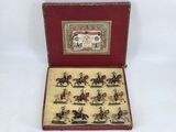 a small box with miniature figurines of people riding horses