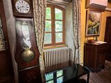 a grandfather clock sitting in the corner of a living room