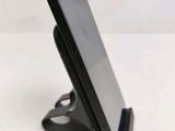 a cell phone that is on a stand on a table