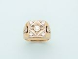 a close up of a gold ring with a diamond in the center