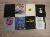 several books are sitting on a wooden floor next to each other