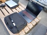 a laptop computer sitting on top of a wooden pallet