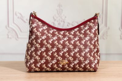 a close up of a purse on a table with a wall in the background