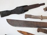 many different types of knives on the table