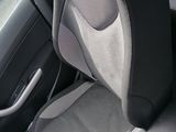a seat in the back of a car with a black and white seat cover