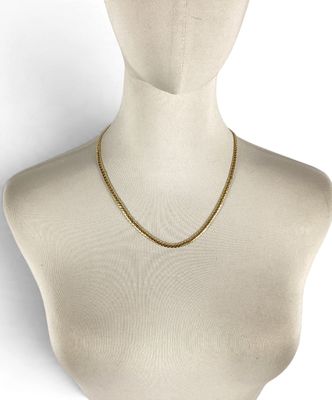 a close up of a mannequin head wearing a gold chain necklace