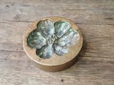 an image of a wooden box with a flower on it