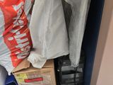 a pile of boxes and bags sitting on the floor